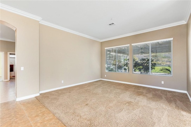 unfurnished room with light tile patterned floors, visible vents, arched walkways, baseboards, and crown molding