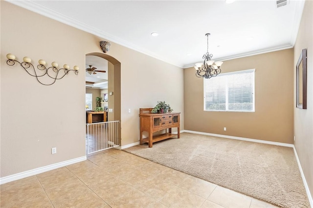 carpeted spare room with a notable chandelier and ornamental molding