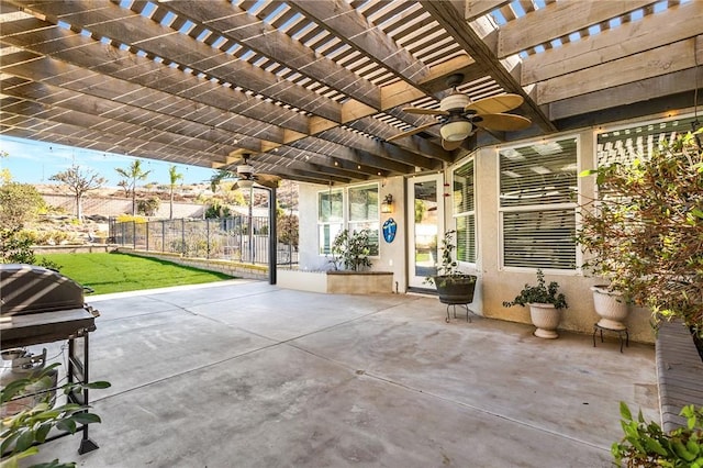 view of patio / terrace with grilling area, fence, a ceiling fan, and a pergola