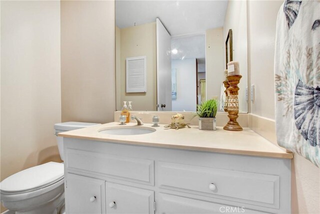 bathroom with vanity and toilet