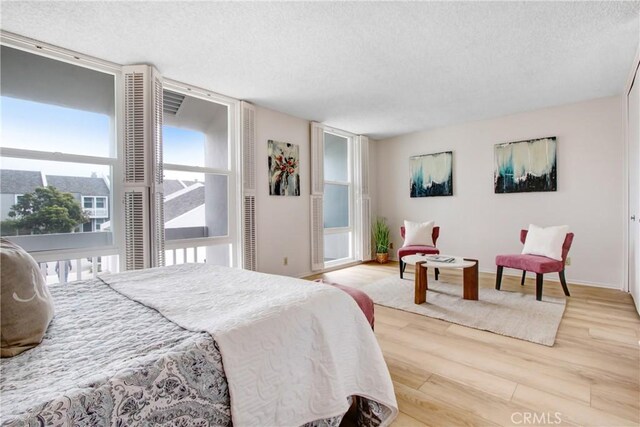 bedroom featuring hardwood / wood-style flooring and a textured ceiling