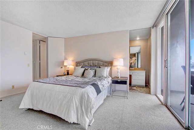 bedroom with light carpet and a textured ceiling