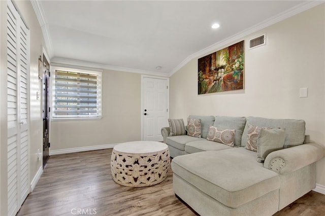 living room with hardwood / wood-style floors and ornamental molding