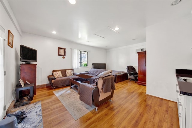 living room featuring light hardwood / wood-style flooring and a wood stove