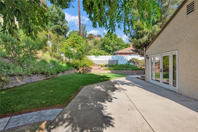 view of yard featuring a patio area and french doors