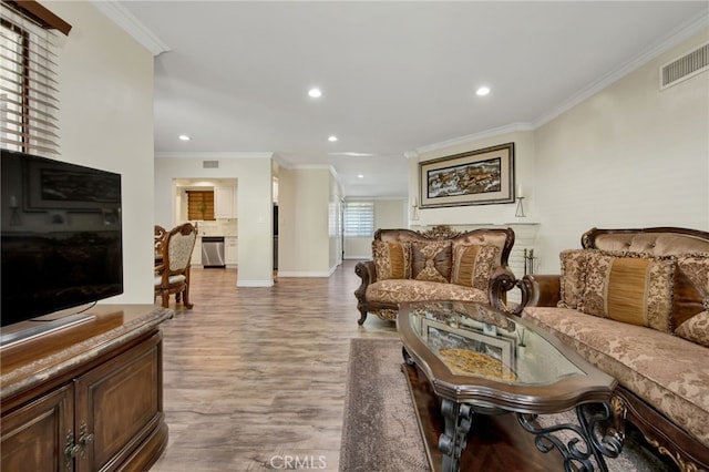 living room with hardwood / wood-style flooring and crown molding