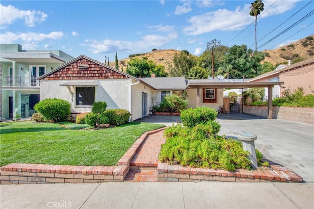 view of front of property with a front yard and a carport