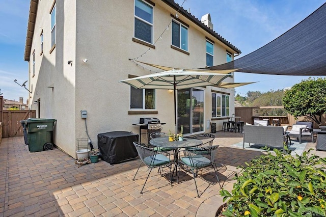 back of house featuring an outdoor living space and a patio