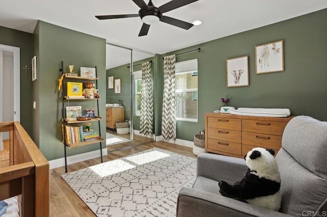 living area featuring ceiling fan and light hardwood / wood-style floors