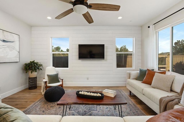 living room with hardwood / wood-style flooring and ceiling fan