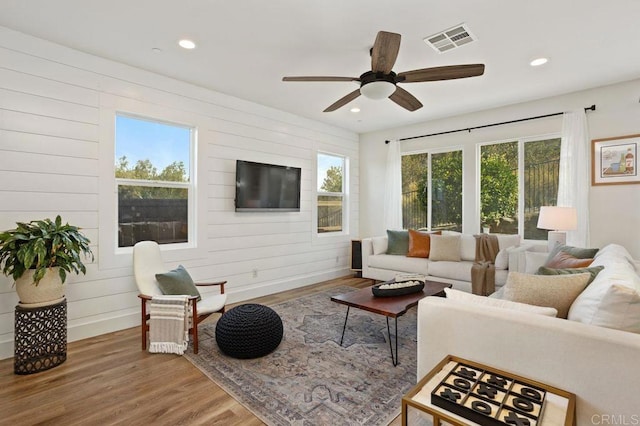 living room with ceiling fan and hardwood / wood-style floors