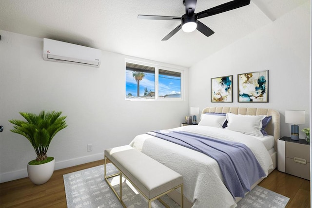 bedroom with vaulted ceiling, dark hardwood / wood-style floors, a wall mounted air conditioner, and ceiling fan