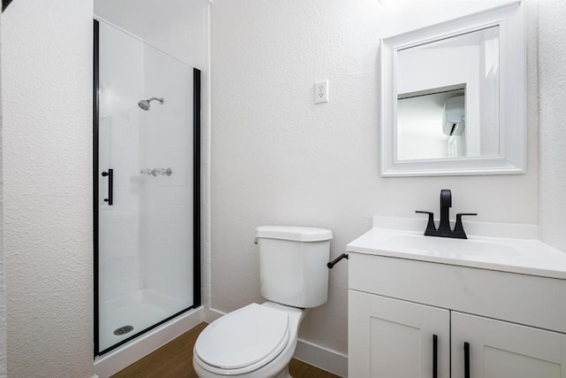 bathroom featuring wood-type flooring, a wall mounted AC, vanity, walk in shower, and toilet