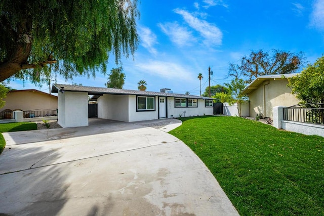 ranch-style house featuring a carport and a front lawn