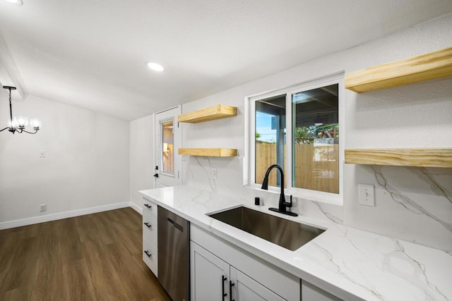 kitchen featuring sink, decorative light fixtures, light stone countertops, and dishwasher