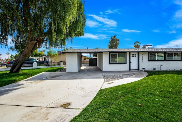 single story home featuring a carport and a front lawn