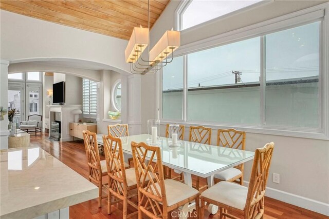 dining room featuring hardwood / wood-style flooring, lofted ceiling, and wood ceiling