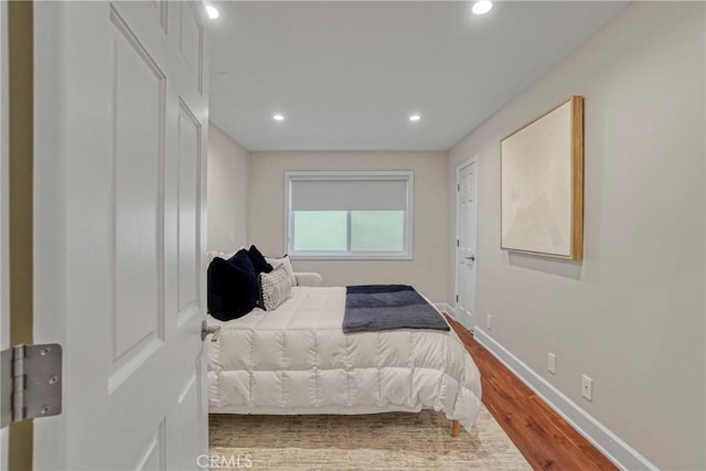 bedroom with recessed lighting, baseboards, and wood finished floors