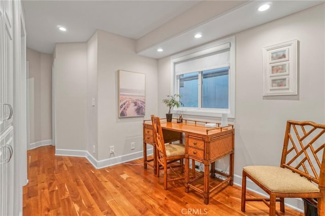 home office with light hardwood / wood-style floors