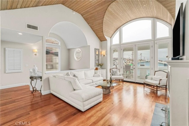 living room with hardwood / wood-style flooring, wood ceiling, and high vaulted ceiling