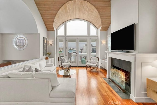 living room featuring hardwood / wood-style floors, wooden ceiling, high vaulted ceiling, and french doors