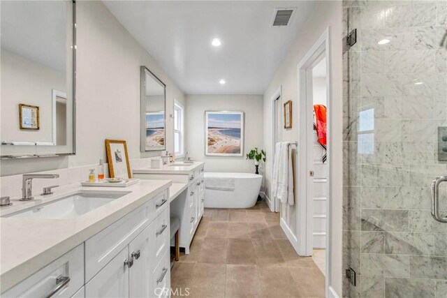 bathroom featuring tile patterned floors, vanity, and separate shower and tub