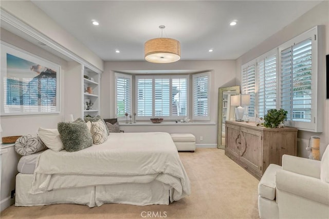 bedroom featuring recessed lighting, multiple windows, and light carpet