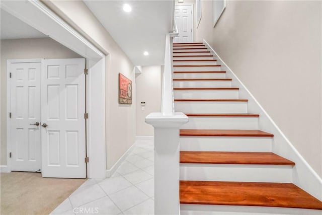 stairs featuring tile patterned floors, recessed lighting, carpet, and baseboards