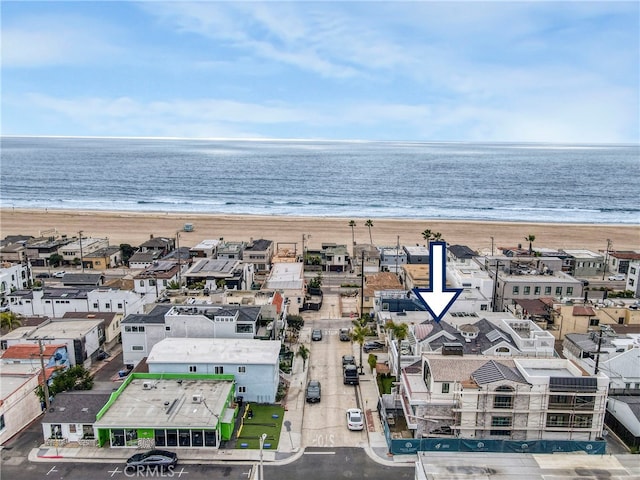 drone / aerial view featuring a water view and a view of the beach