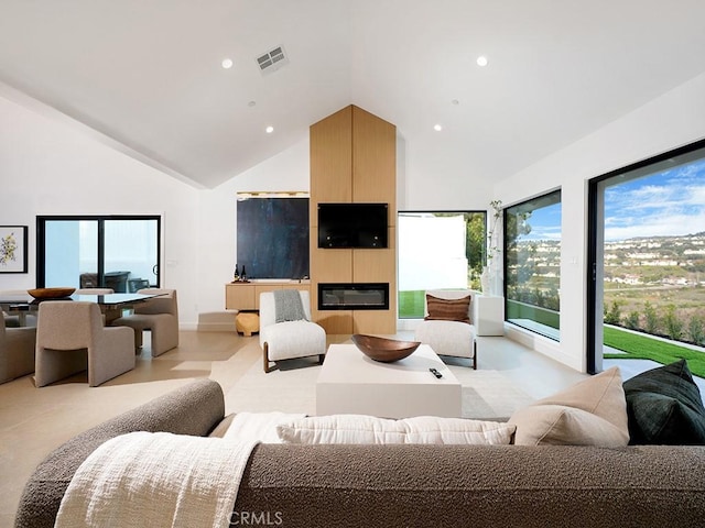 living room with a fireplace and high vaulted ceiling