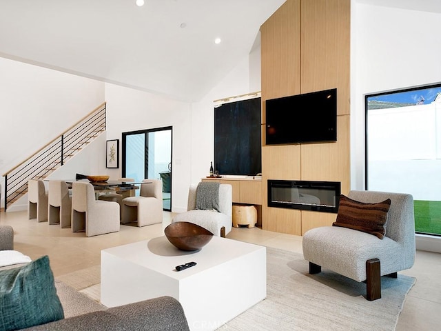 living room with high vaulted ceiling