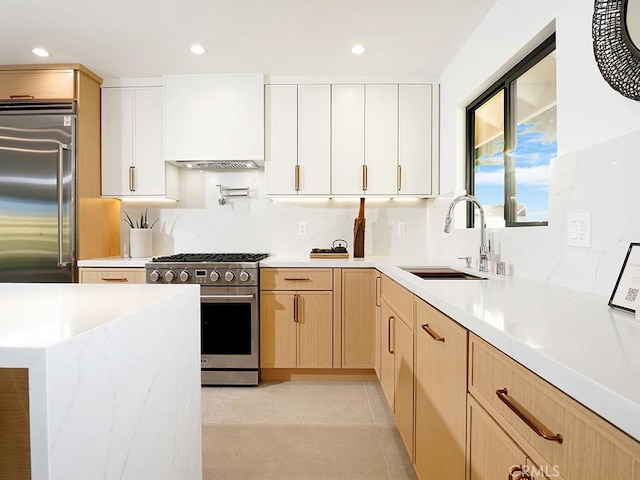 kitchen with stainless steel appliances, sink, white cabinets, and decorative backsplash