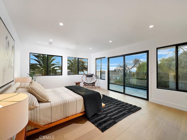 bedroom featuring light wood-type flooring and access to outside