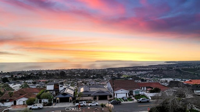 aerial view at dusk with a water view