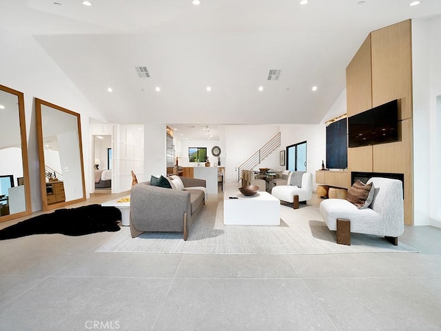 living room with high vaulted ceiling