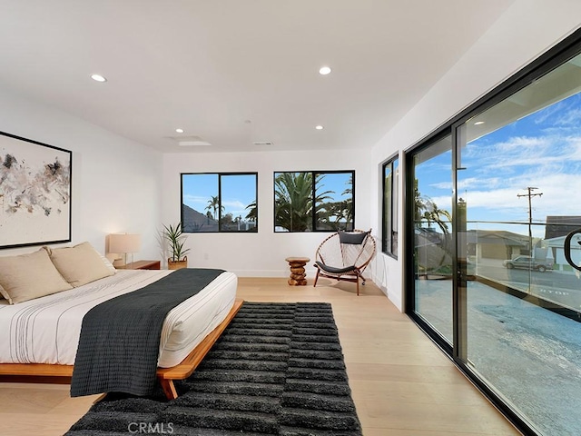 bedroom featuring access to outside and light wood-type flooring