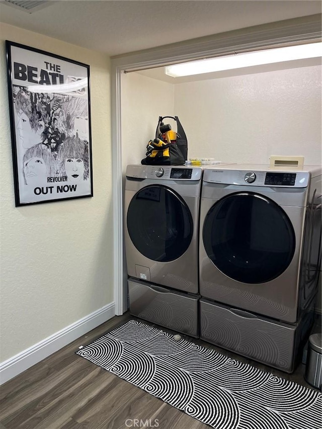 laundry area with independent washer and dryer and hardwood / wood-style floors