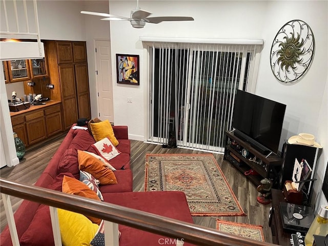 living room featuring dark hardwood / wood-style floors and ceiling fan