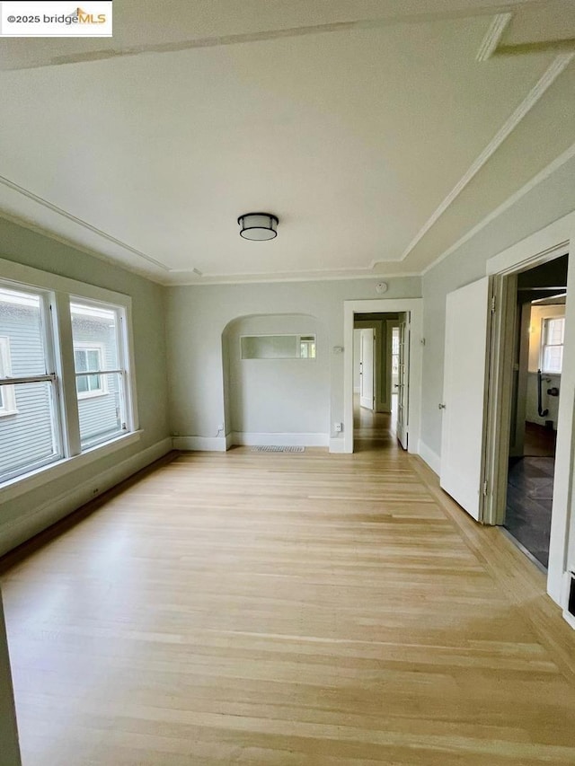 unfurnished room with ornamental molding and light hardwood / wood-style flooring