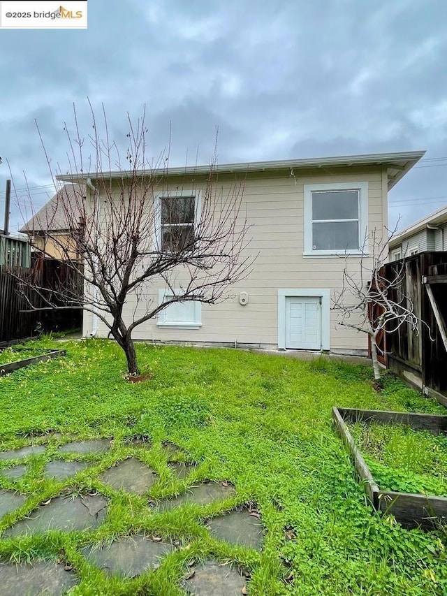 rear view of house with a yard