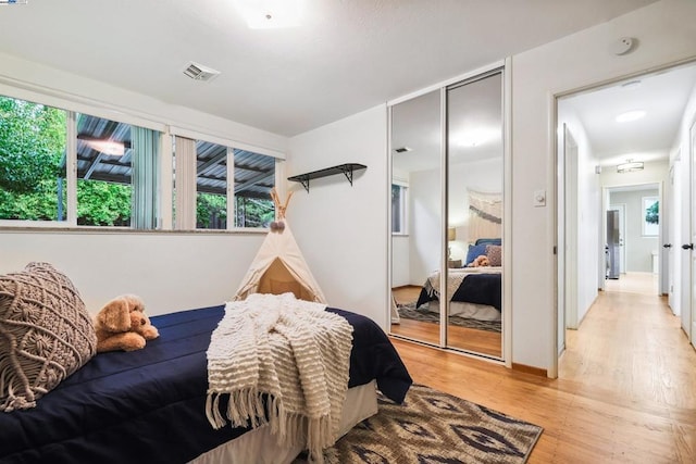 bedroom with a closet and light wood-type flooring