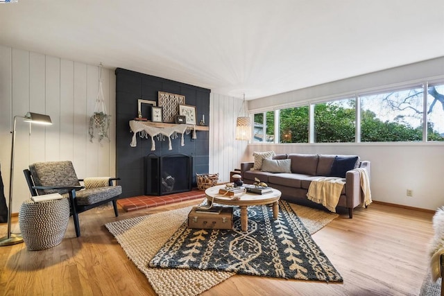 living room featuring hardwood / wood-style floors, a wealth of natural light, and a fireplace