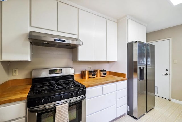 kitchen featuring white cabinetry, appliances with stainless steel finishes, wooden counters, and range hood