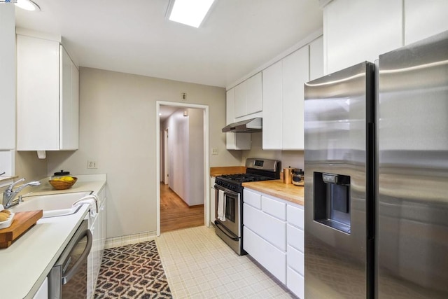 kitchen with sink, stainless steel appliances, and white cabinets