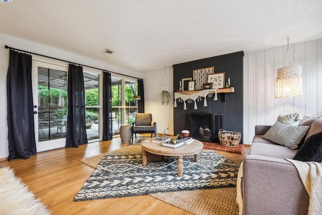 living room with hardwood / wood-style flooring and a fireplace