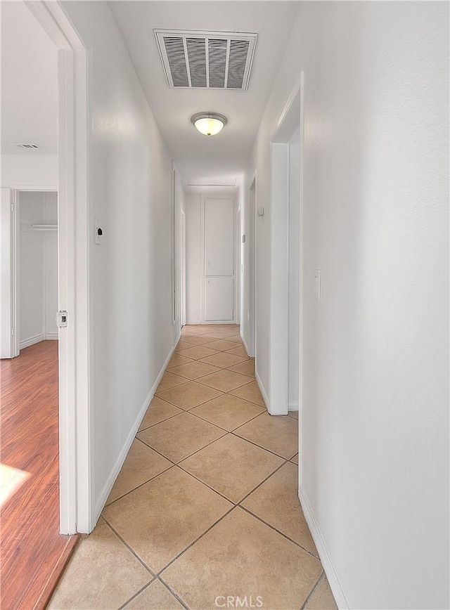 hallway featuring light tile patterned floors