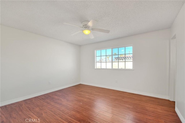 unfurnished room featuring ceiling fan, wood-type flooring, and a textured ceiling