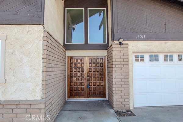 view of exterior entry with a garage