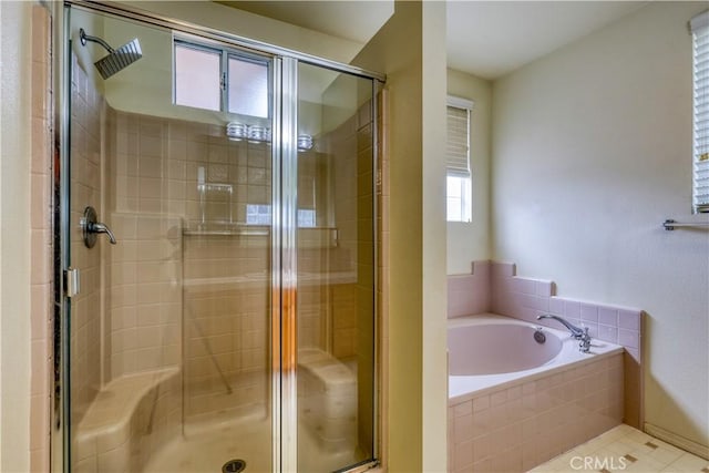 bathroom featuring shower with separate bathtub