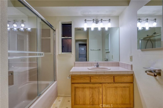 bathroom with vanity and combined bath / shower with glass door